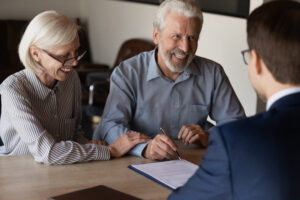 Happy mature family couple of clients consulting legal expert